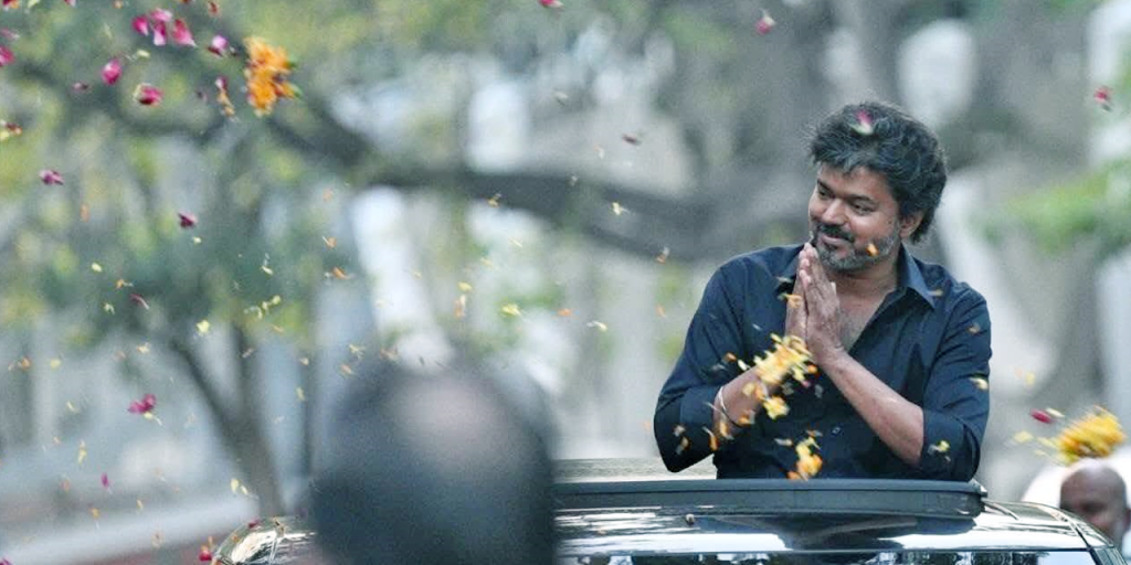 Actor Vijay waves to fans after coming out of CBI office
